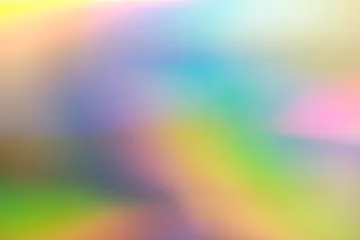 A blurred rainbow gradient resembling pools of shifting hues on a rainbow oil slick